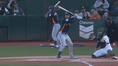 Baseball Player Swinging At Pitch Before Chevron Sign GIF