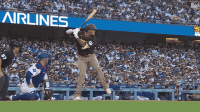 Baseball Player Swinging At Pitch In Front Of Airlines Banner GIF