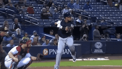 Baseball Player Swinging At Pitch In Front Of PNB Bank Banner GIF
