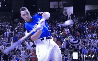 Baseball Player Swinging Bat At Ball Before Crowd GIF