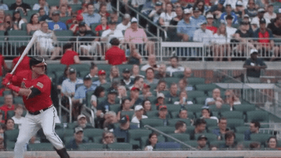 Baseball Player Swinging Bat At Ball In Crowd GIF