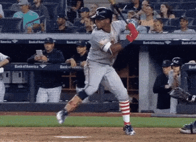 Baseball Player Swinging Bat At Ball With Crowd Watching GIF
