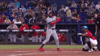 Baseball Player Swinging Bat With Geico Banner GIF