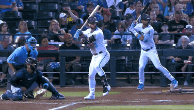 Baseball Player Swinging While Another Watches GIF