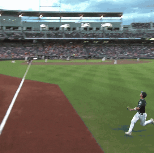 Baseball Player Throwing Ball In Front Of Crowd At Stadium GIF
