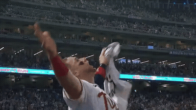 Baseball Player Throws Ball Under Delta Sky Banner GIF