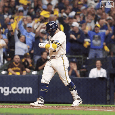 Baseball Player Walking Towards Home Plate With J.com Banner