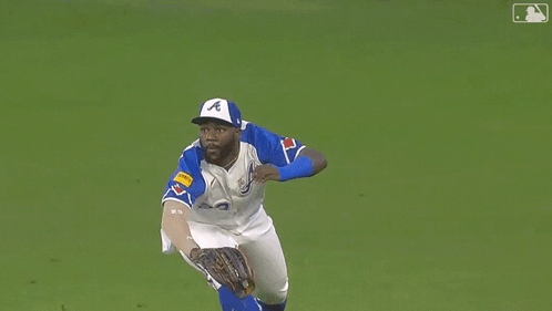 Baseball Player Wearing Number 23 Lying On Grass GIF