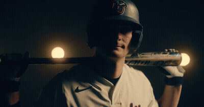 Baseball Player With U Helmet Holding Bat Over Shoulder GIF