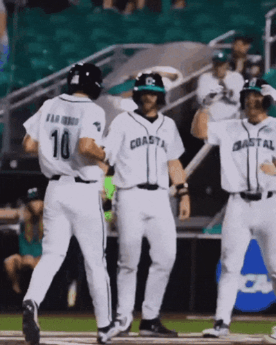 Baseball Players For The Coastal Team Are Celebrating A Home Run GIF