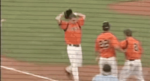 Baseball Players Hugging On Field GIF