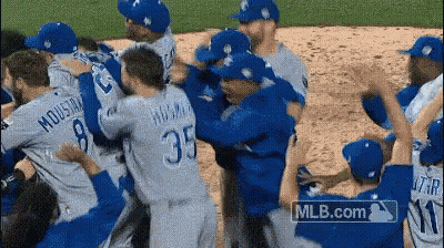 Baseball Players Hugging On Field With MLB.com Logo GIF