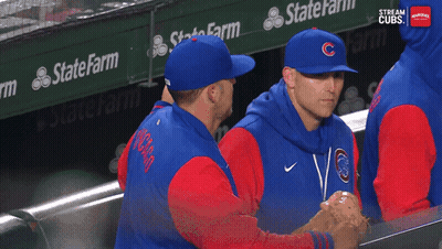 Baseball Players In A Dugout With A State Farm Banner Behind Them GIF