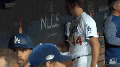 Baseball Players In Dugout One Wearing LA Hat GIF