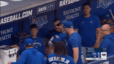 Baseball Players In Dugout With Bayfront Health And Rays Ads GIF