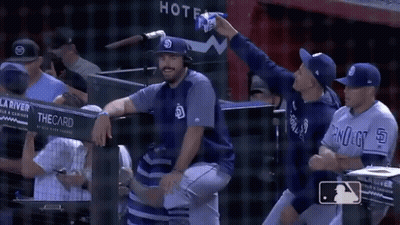 Baseball Players In Dugout With Sign Saying Thecard GIF