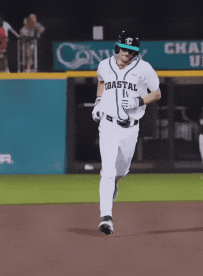 Baseball Players In Teal Shirts And Black Hats Watching Game GIF
