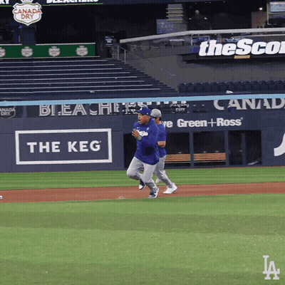 Baseball Players Running On Field With Keg Sign GIF