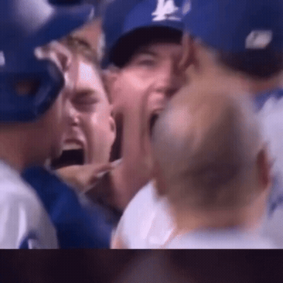 Baseball Players Screaming In Crowd Wearing Blue Hats GIF