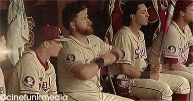 Baseball Players Sitting In Dugout GIF