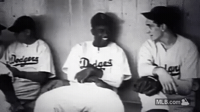 Baseball Players Sitting In Dugout Talking GIF