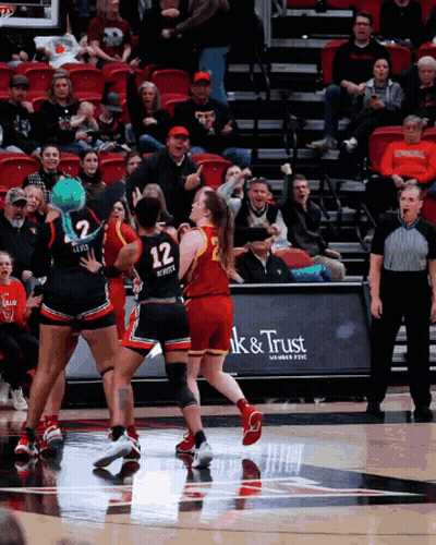 Basketball Game In Front Of Ak & Trust Sign GIF