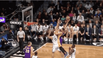 Basketball Game In Front Of Crowd With Geico Sign GIF