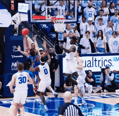 Basketball Game In Front Of Qualtrics XM Sign GIF