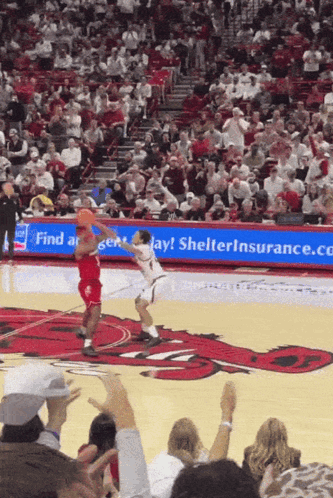 Basketball Game In Front Of Shelter Insurance Sign GIF