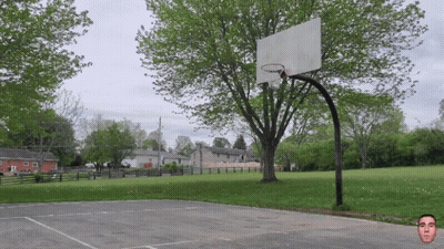 Basketball Hoop Surrounded By Trees And Houses GIF