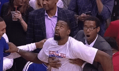 Basketball Player Held By Suited Man In Stands GIF