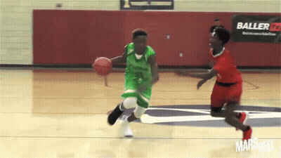 Basketball Player In Green Dribbling Past Red Player GIF