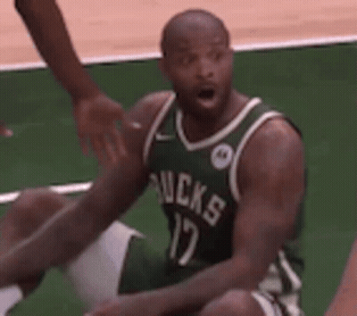 Basketball Player In Green Jersey Sitting On Floor GIF
