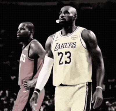 Basketball Player In Lakers Jersey Standing Next To Another Player GIF