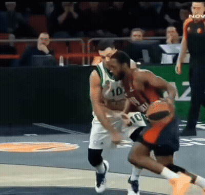 Basketball Player In Number 10 Jersey Blocking Another Player GIF