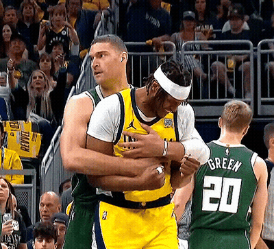 Basketball Player In Number 20 Jersey Hugging Another Player GIF