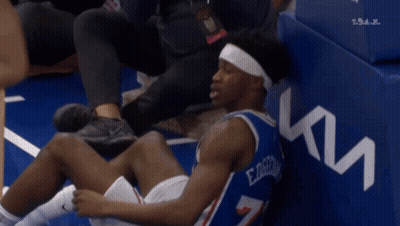 Basketball Player In Number 7 Jersey Sitting On Floor GIF