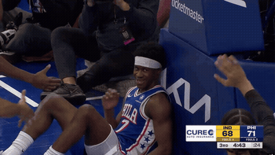 Basketball Player In Philadelphia Jersey Sitting On Floor GIF
