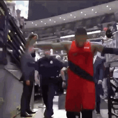 Basketball Player in Red Uniform Standing in Stadium