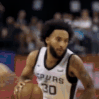 Basketball Player in Spurs Jersey Dribbling