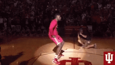 Basketball Player Jumping in Air on Court