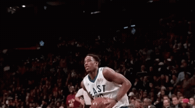 Basketball Player Jumping With Ball In Front Of Crowd GIF