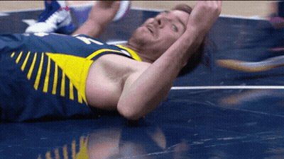 Basketball Player Laying On Floor With Arms In Air GIF