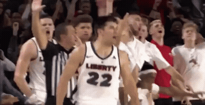Basketball Player Number 22 Surrounded By Teammates GIF