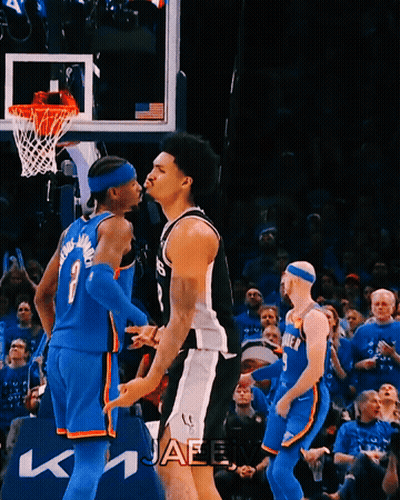 Basketball Player Number 7 Standing Next To Another Player GIF