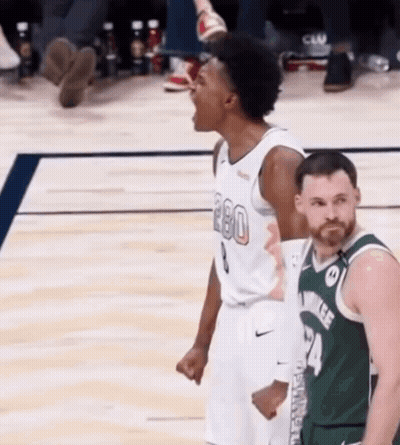 Basketball Player Screaming In The Air With Opponent GIF