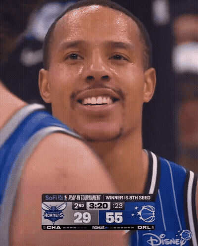 Basketball Player Smiling At Scoreboard GIF