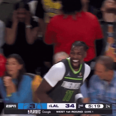 Basketball Player Smiling In Stands GIF