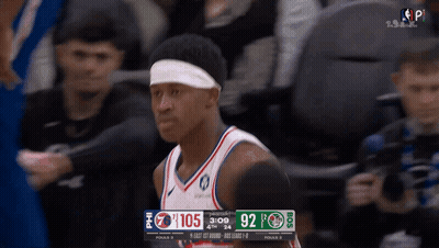 Basketball Player With Headband In Front Of Scoreboard GIF