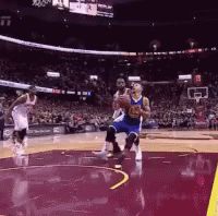 Basketball Players Are Playing A Game Of Basketball In A Stadium With A Crowd Watching . GIF